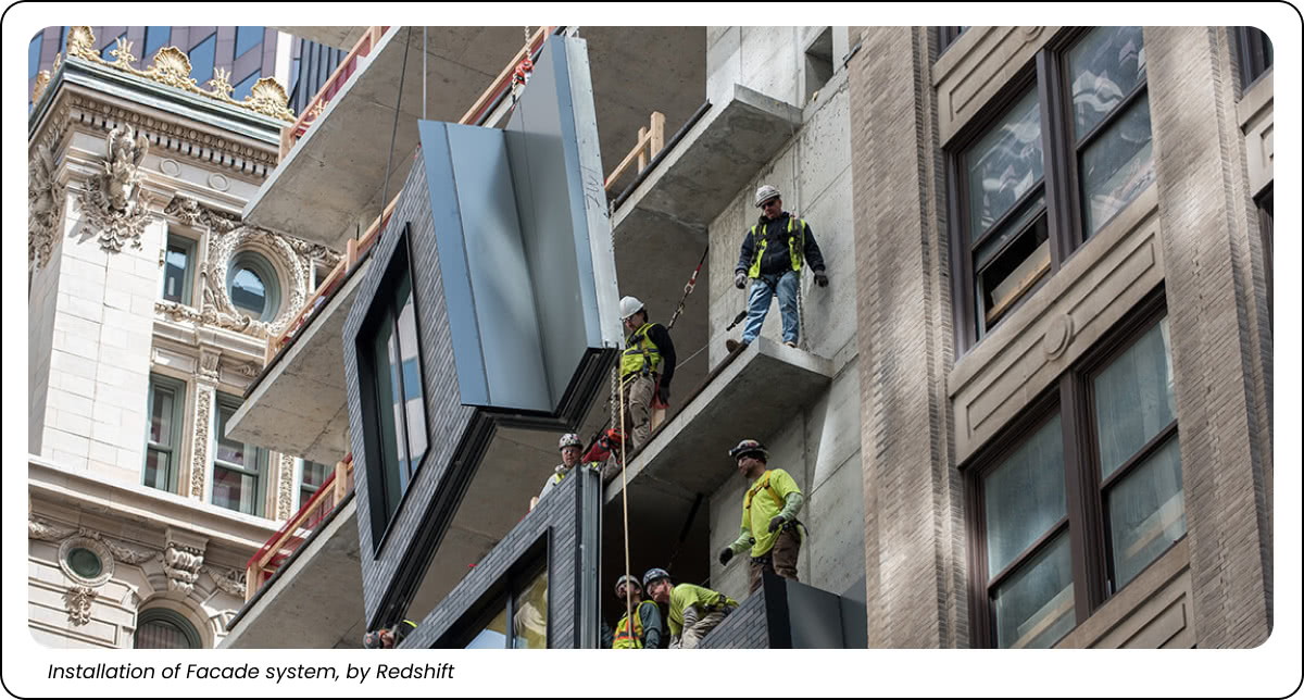 This is a picture showing a window being placed on a building.
